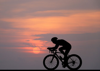 Canvas Print - Silhouette  Cycling  on blurry sunrise  sky   background.