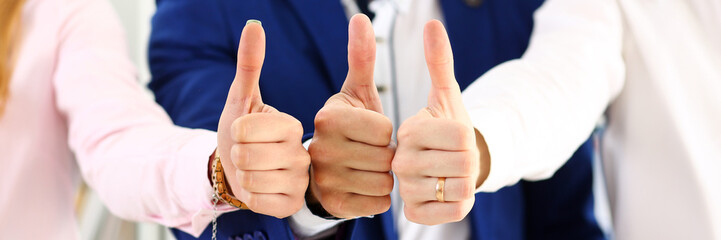 Group of people show OK or approval with thumb up during conference closeup. High level quality product, serious offer, excellent education, mediation solution, creative advisor participation concept