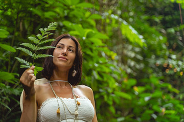 Wall Mural - Happy woman relaxinhg in tropical forest stock photo