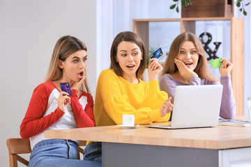 Sticker - Young women using laptop for online shopping at home