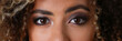 A beautiful black woman with a large face portrait. On a gray background a smiling beauty fashion style curly hair with white locks eye view of the camera