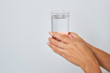 female hand holding a glass of water