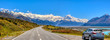 The panorama of the mountains and the lake pukaki during the summer, when the sky is clear, cars parked on the side of the road in Mount Cook National Park in south island of New Zealand
