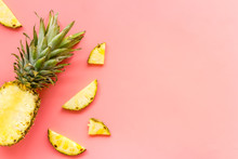 Pineapple - Half Of Fruit And Slices - On Pink Background Top-down Copy Space