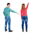 © ghoststone - Back view of couple couple in sweater pointing.