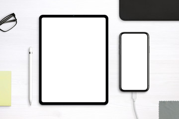 Poster - Tablet and phone mockup on desk. Top view, flat lay scene with separated layers