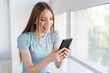 © FreepikCompany - Happy woman checking her phone