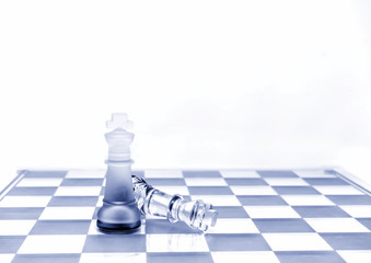 Two King chess pieces on a board in red