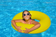 © SuperCoolPhotography - Real adorable girl relaxing in swimming pool
