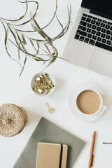 Wall Mural - Home office desk workspace with laptop, coffee cup, notebook, glasses, pen, green plant branch on white background. Flat lay, top view girl boss work business concept for lifestyle blog, social media.
