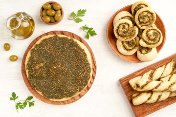 Freshly baked   manakeesh, swirls and straws with zaatar . Top view with copy space  