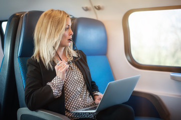 Businesswoman woman traveling using laptop in train