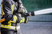 Firefighters Who Use Fire Extinguishers And Hose Water To Fight Fires