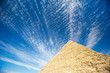 Blue sky view of the Great Pyramid with dramatic cloudscape in Giza, Egypt