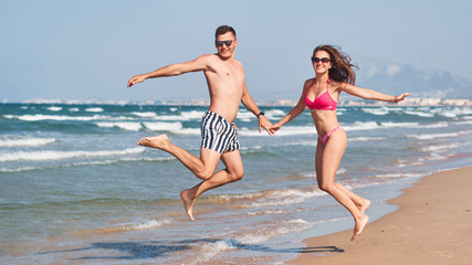 Young couple in love walking on the beach.