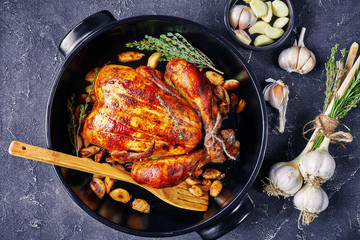 Canvas Print - forty cloves chicken in a black baking dish