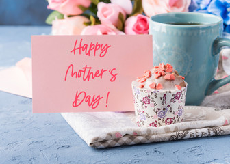 Happy mothers day greetings. Holiday greeting card with lettering text, cup of tea and cupcake