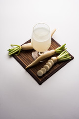 Wall Mural - Healthy Fresh daikon juice or Mooli extract drink in a glass with raw mule