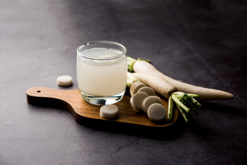 Wall Mural - Healthy Fresh daikon juice or Mooli extract drink in a glass with raw mule