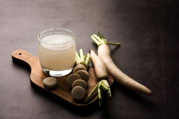 Wall Mural - Healthy Fresh daikon juice or Mooli extract drink in a glass with raw mule