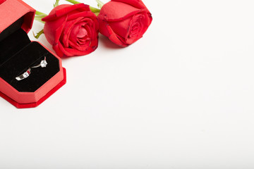 Diamond rings and gift boxes on roses