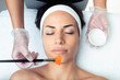 © nenetus - Cosmetologist making a chemistry peeling for rejuvenating the face to woman on the spa center.