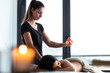 © nenetus - Beautiful young woman applying hot wax from a candle for back massage to a pretty woman on the spa center.