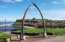 A View Of Whitby Abbey Seen Under A Blue Sky Through A Whale Bone Arch At Whitby, North Yorkshire UK