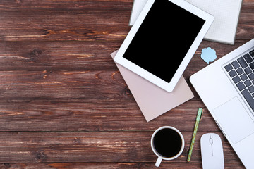 Wall Mural - Laptop and tablet computer with notepads and cup of coffee on wooden table