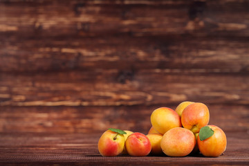 Sweet apricots on brown wooden table