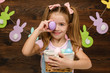 © producer - happy little child girl holding basket with painted Easter eggs. Easter day