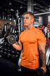 © JonoErasmus - Muscular young man working out with dumbbells in a gym