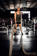 © JonoErasmus - Fit young man working out with battle ropes
