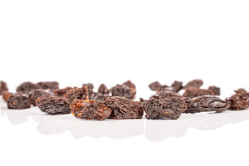 Wall Mural - Lot of whole dried dark raisin front focus isolated on white background