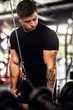 © JonoErasmus - Muscular young man doing cable tricep pulldowns exercises