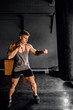 © JonoErasmus - Fit young man working out on a gym punching bag