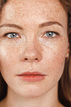 Freestyle. Young Woman With Freckles Standing Serious Face Close-up