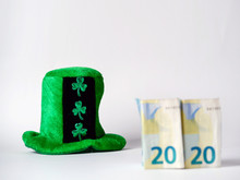 Green Hat With Shamrock Two Euro Banknotes Folded Making 2020 Year Saint Patrick Day Celebration. Bright Background, Copy Space.
