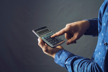 man holds a calculator