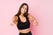 © Asier - Young caucasian fitness woman doing sport isolated cheerful smiles pointing to front.