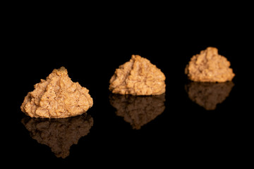 Wall Mural - Group of three whole homemade brown coconut biscuit with chocolate placed diagonally isolated on black glass