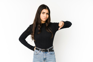 Wall Mural - Young indian woman isolated on purple background showing thumb down, disappointment concept.