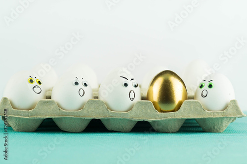 Golden Egg Among Agressive Angry White Eggs In A Paper Tray Hate In Group Jealousy Xenophobia Concept Stock Photo Adobe Stock