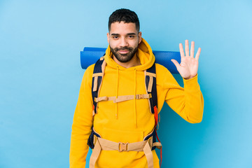 Wall Mural - Young arabian traveler backpacker man isolated smiling cheerful showing number five with fingers.