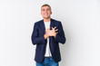 © Asier - Young business caucasian man laughing keeping hands on heart, concept of happiness.