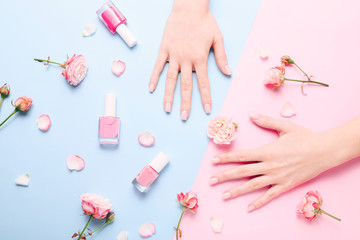 Beautiful woman manicure on creative trendy pink and blue background.