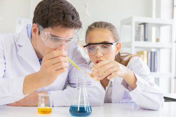 Poster - Male and female scientists working in a science laboratory with various equipment in the laboratory.