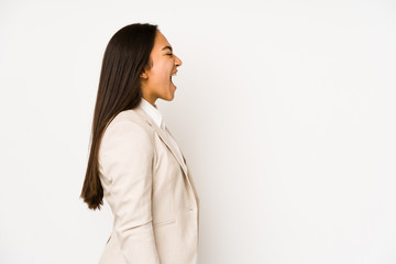 Wall Mural - Young woman isolated on a white background shouting towards a copy space