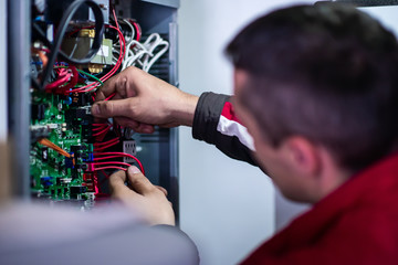 electrician engineer working with electric cable wires