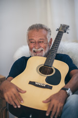 Wall Mural - The old man and his guitar in the house